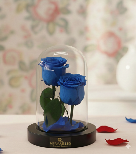 Two blue roses in a glass dome
