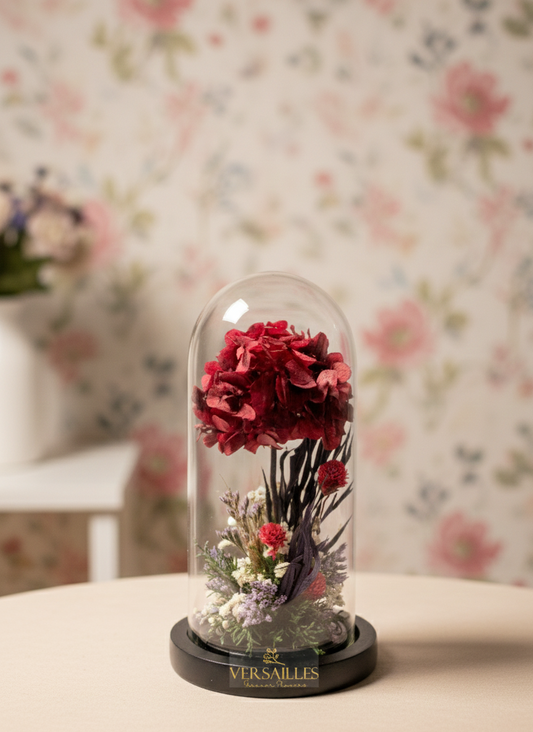 Decorative glass dome with red flowers on a floral-patterned wall background
